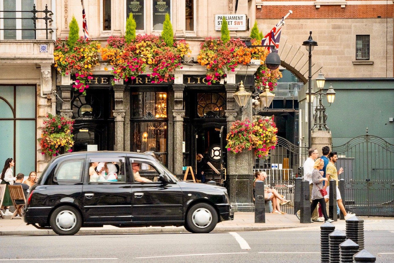 A black cab cruises by The Red Lion, at 48 Parliament St. in London. Given its proximity to the United Kingdom's political institutions, including the Houses of Parliament, the pub is famous for its patrons who work in government.