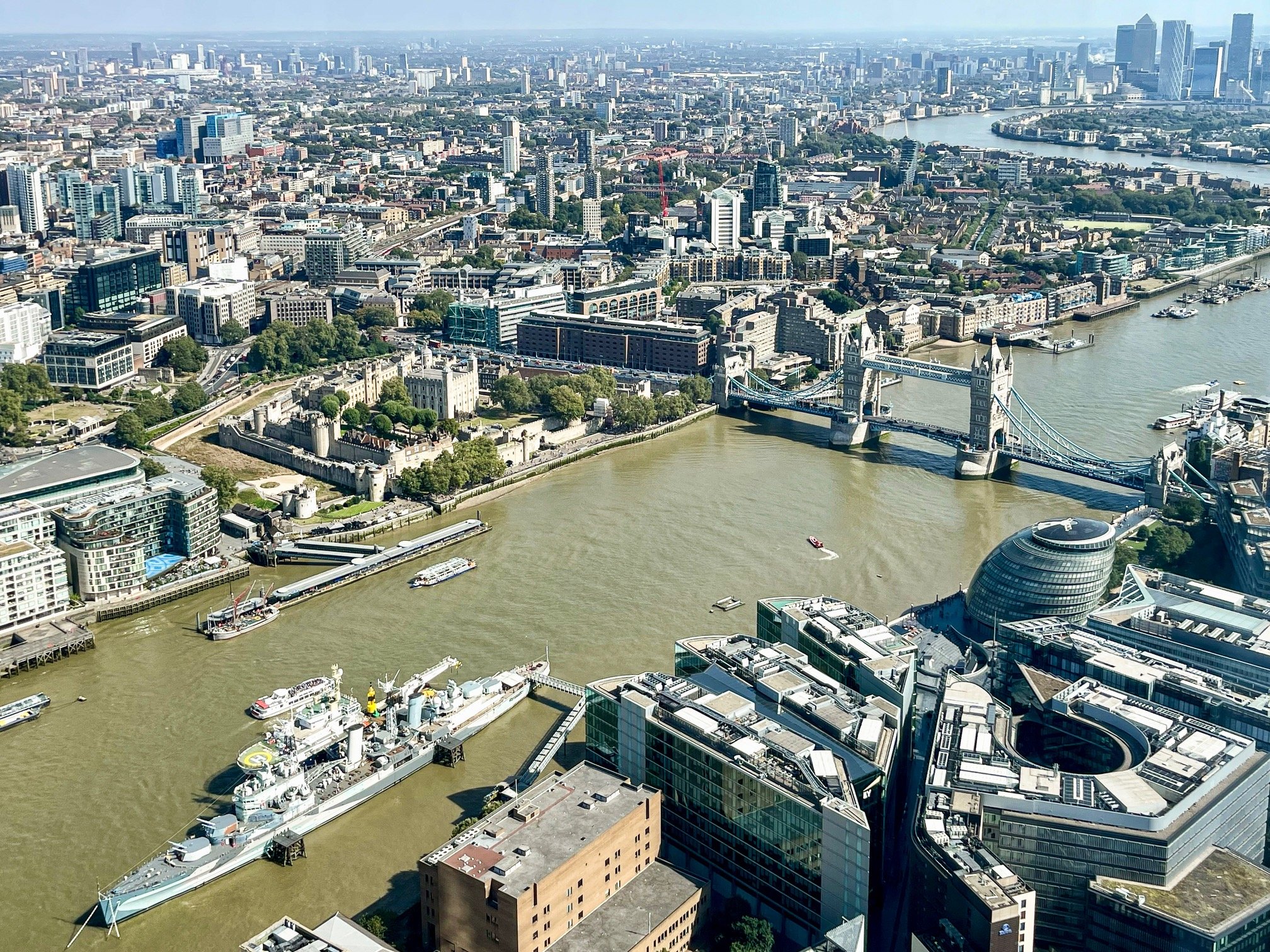 The Tower Bridge and the North and South banks of the Thames River seen from the observation deck on the 69th floor of The Shard, London’s tallest skyscraper. The Royal Navy’s World War II-era battleship HMS Belfast is permanently docked on the rive