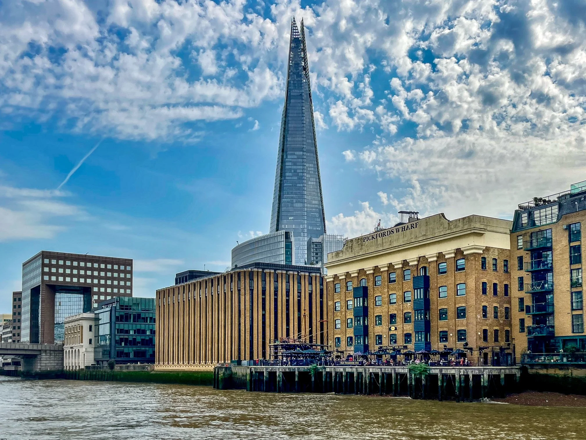  The Shard soars over Pickfords Wharf along the south bank of the River Thames. Originally built by Fitch &amp; Cozens as Phoenix Wharf, this historic riverside building once stored everything from canned goods and sugar to dried fruit. After Pickfor