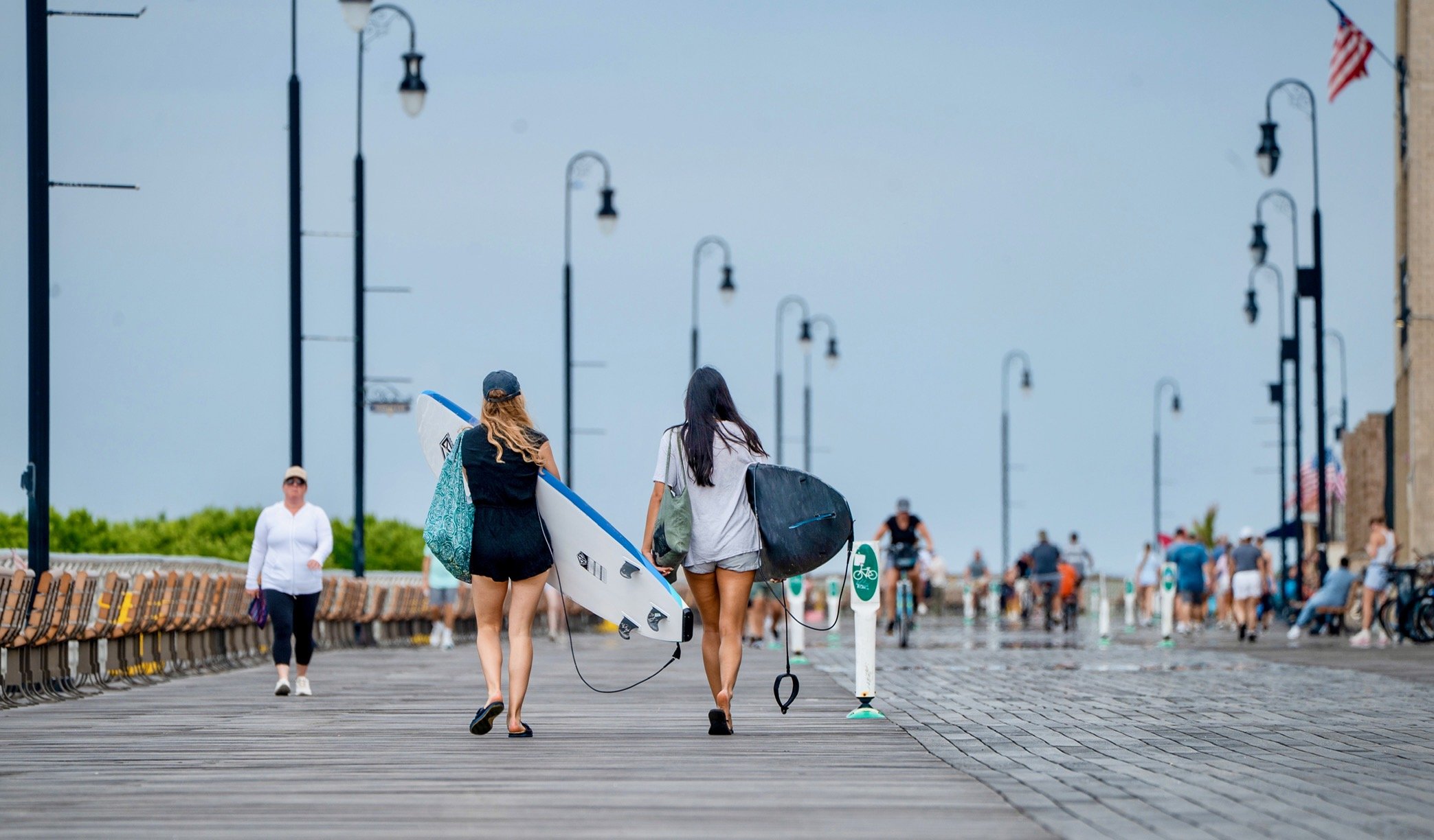 @ Women sufers walk boardwalk_Long Beach_Photo Joseph Kellard.jpg