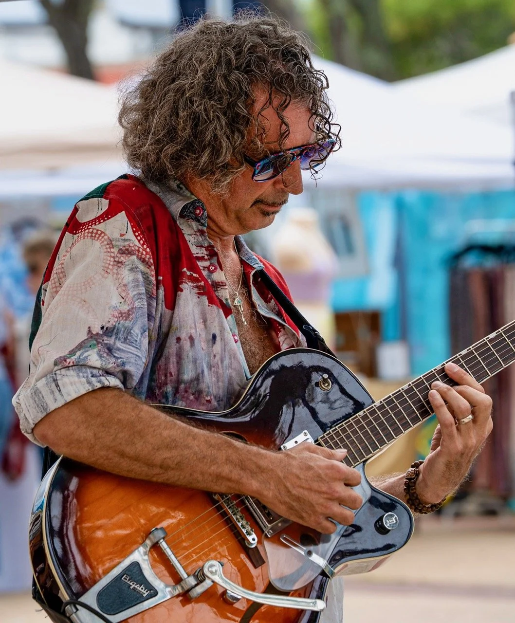  Ben “Benoir” Metzger lights up Arts in the Plaza in Long Beach, NY, on his guitar. 