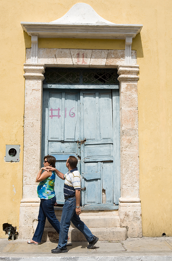  A couple walks down a quiet street in Campeche, Mexico. 