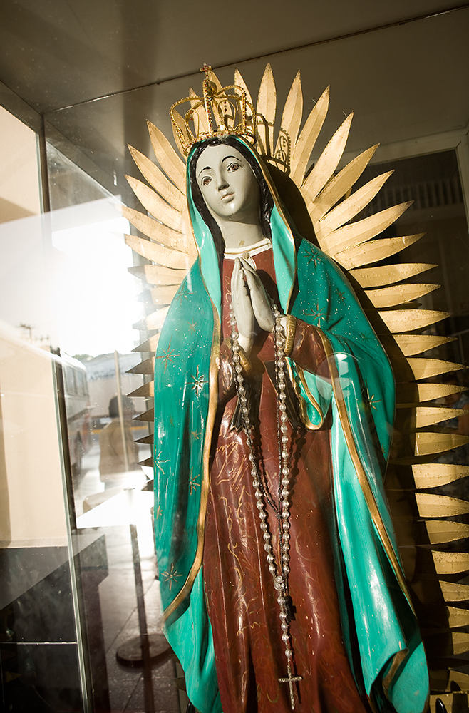  The Virgin of Guadalupe, a Mexican religious and cultural icon, watches over the bus station in Valladolid. 
