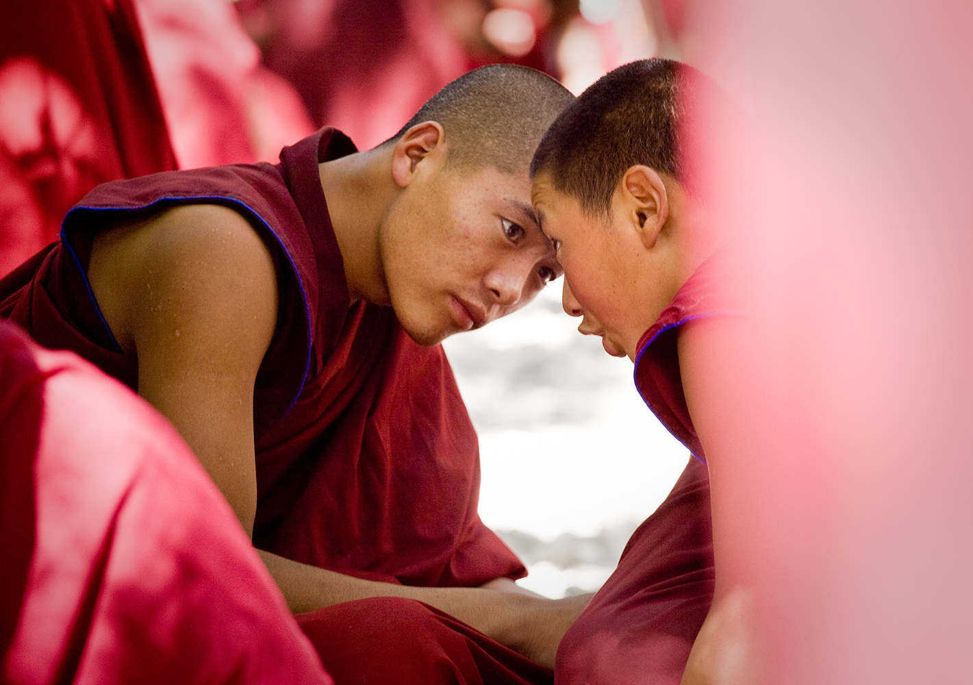  Two monks sit deep in conversation at Sera monastery outside of Lhasa. Every afternoon the monks debate about Buddhist principles and theology. 