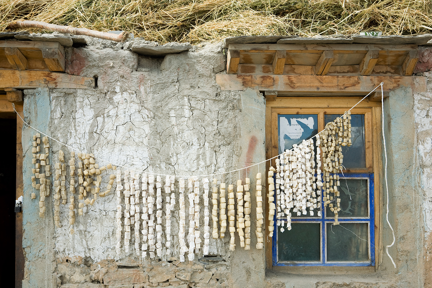  Squares of yak cheese, a hard mass that is eaten like candy, dries outside a home. 