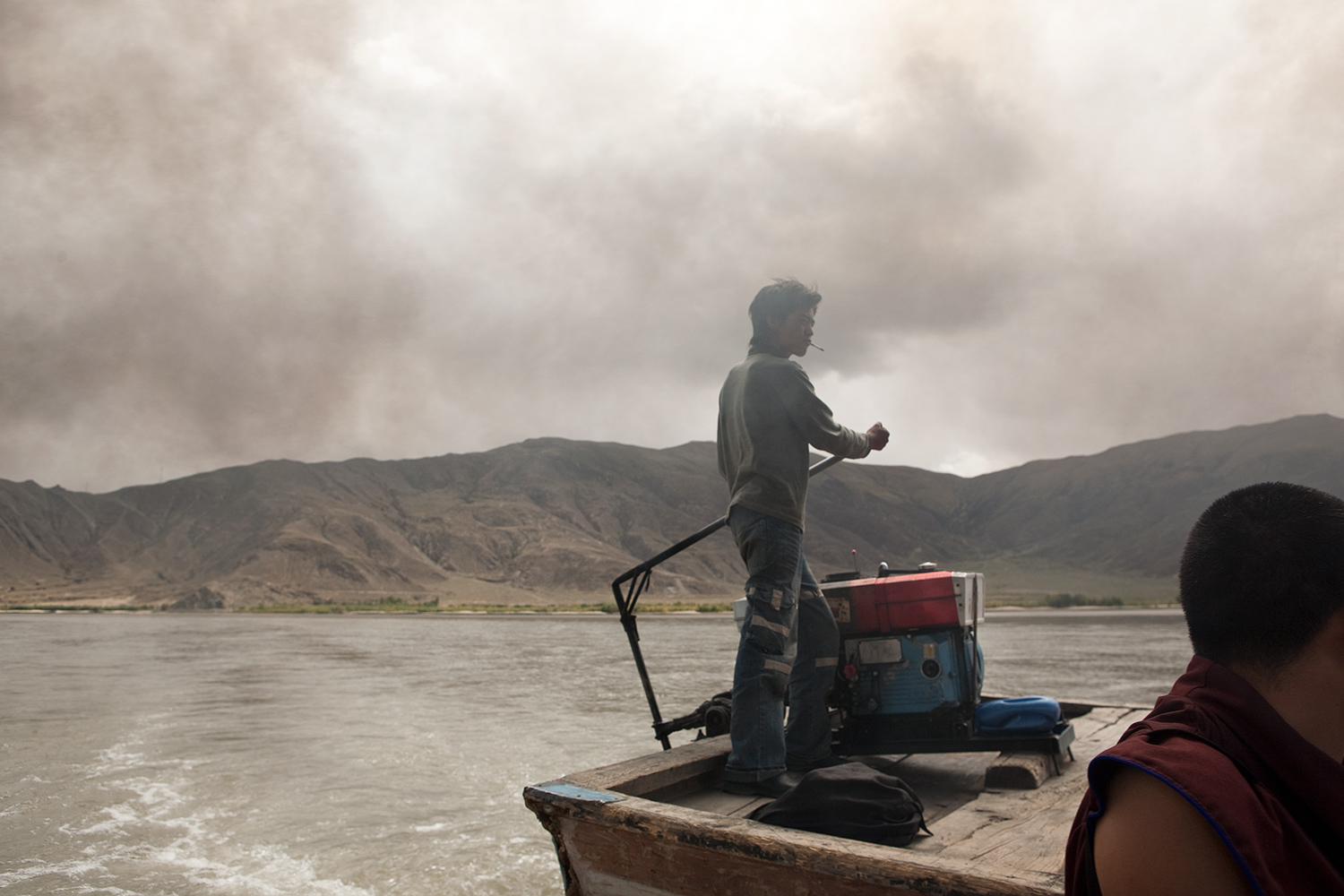  A man navigates a ferry across the Yarlung Tsangpo river for pilgrims traveling to Samye monastery, the oldest monastery in Tibet.  