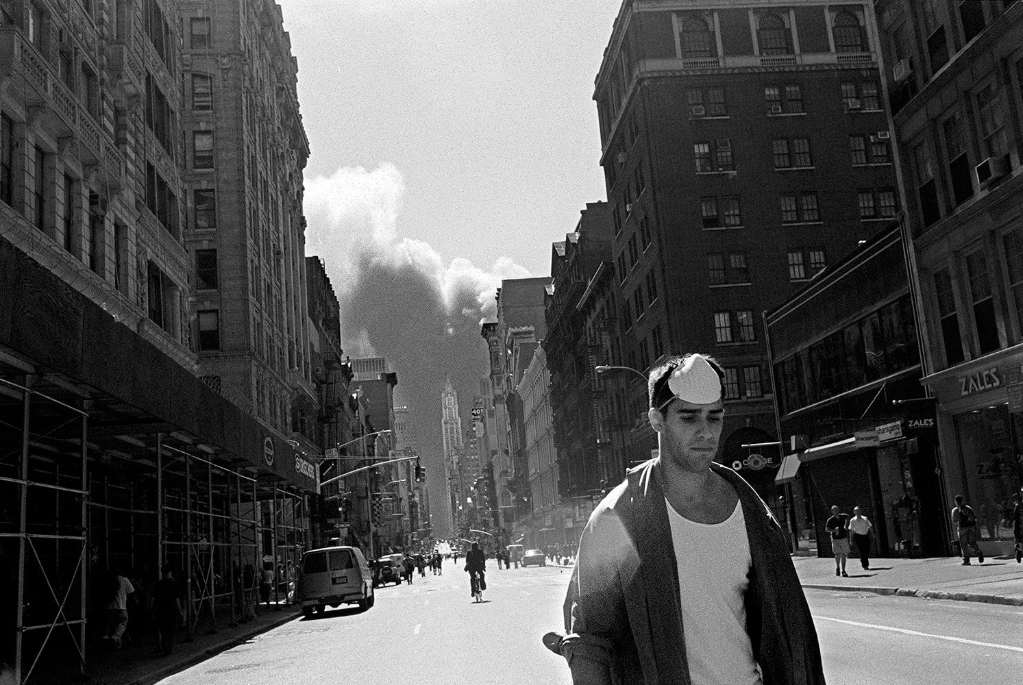  A man walks north away from the burning remains of the World Trade Center towers on September 11th. 