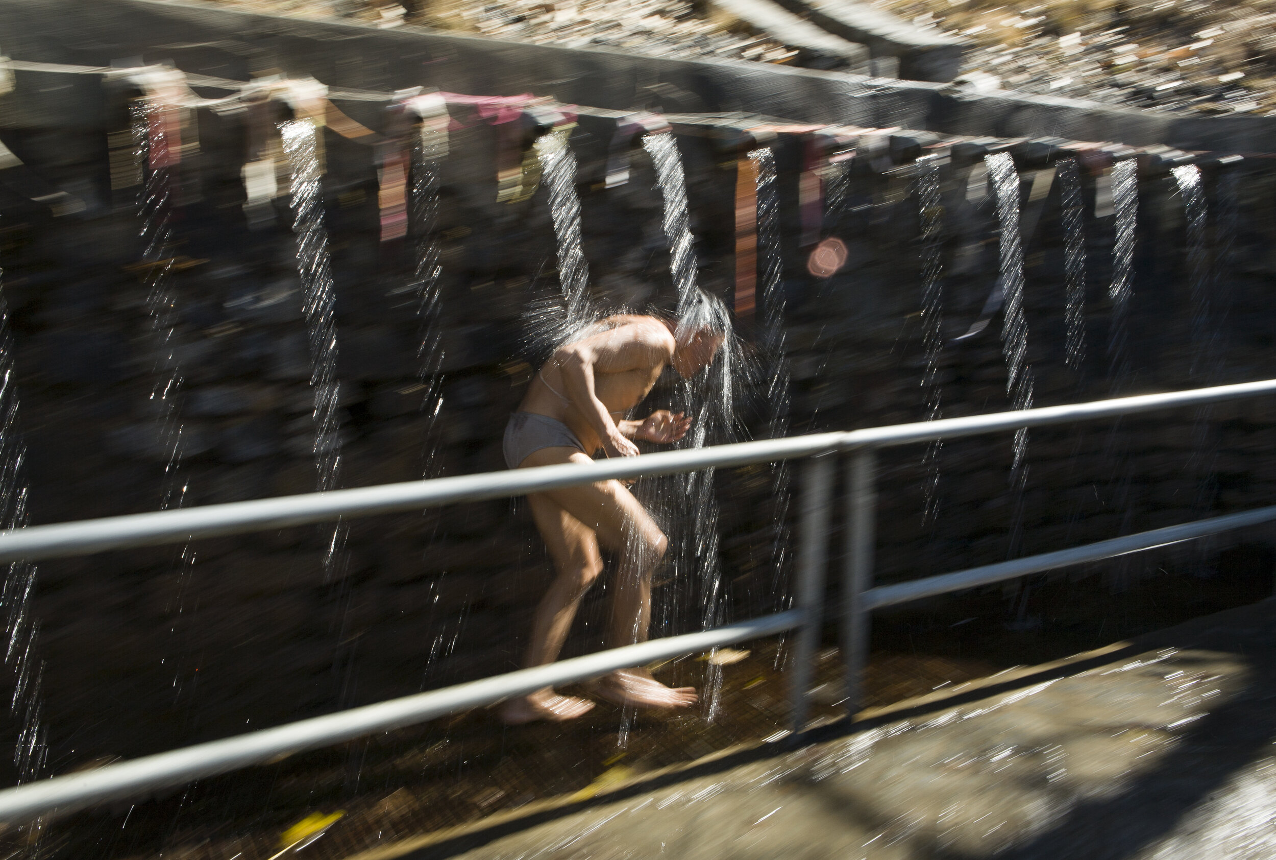  A pilgrim sprints underneath the 108 waterspouts of the Muktinath-Chumig Gyatsa temple. The number 108 is auspicious in both Buddhism and Hinduism, and receiving the water from each spout purifies the pilgrim. 