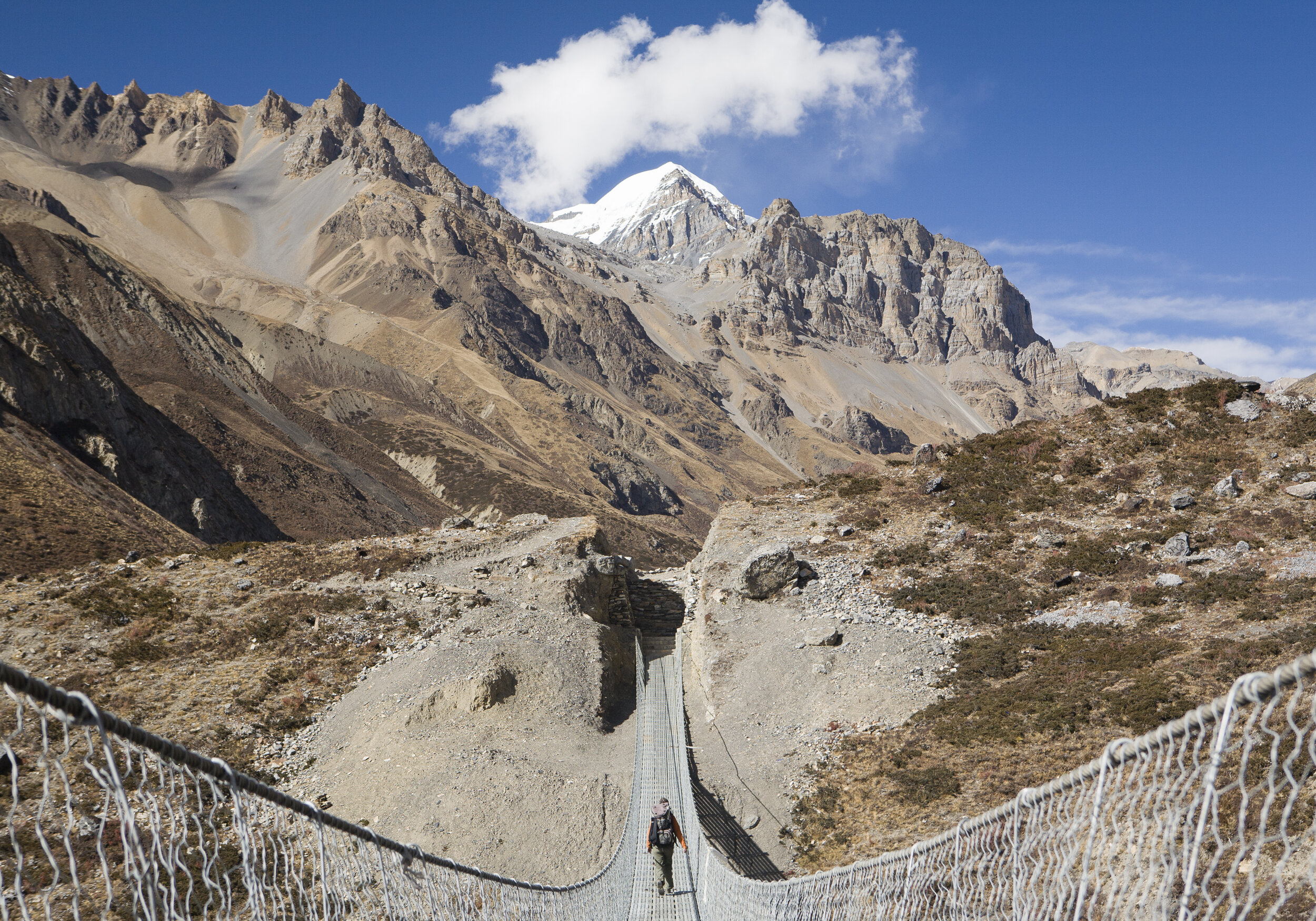  German trekker Anne Sablotny crosses a bridge near Ledar. The Thorong La Pass, the apex of the trail, is a two-day uphill climb from Ledar. 