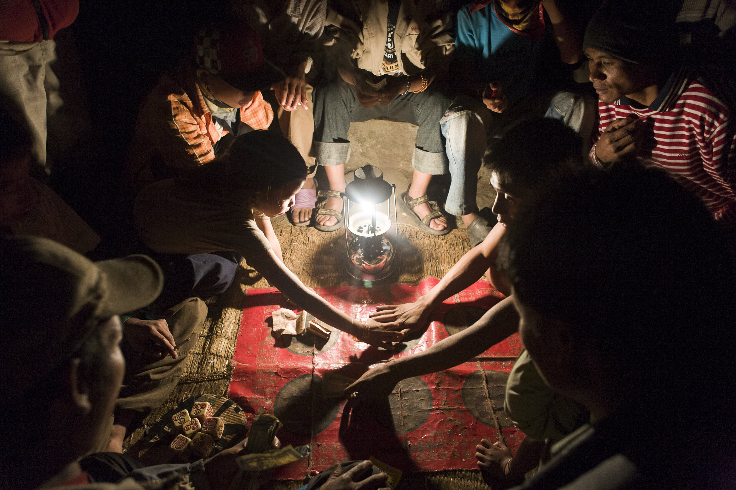  In the tiny village of Jagat on the Annapurna Circuit trail, both young and adult locals play a Nepali betting game. 