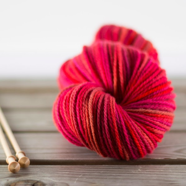 Columbia Aran in Blood Orange ; most of the colors in this semi-solid skein are shades of red-orange.