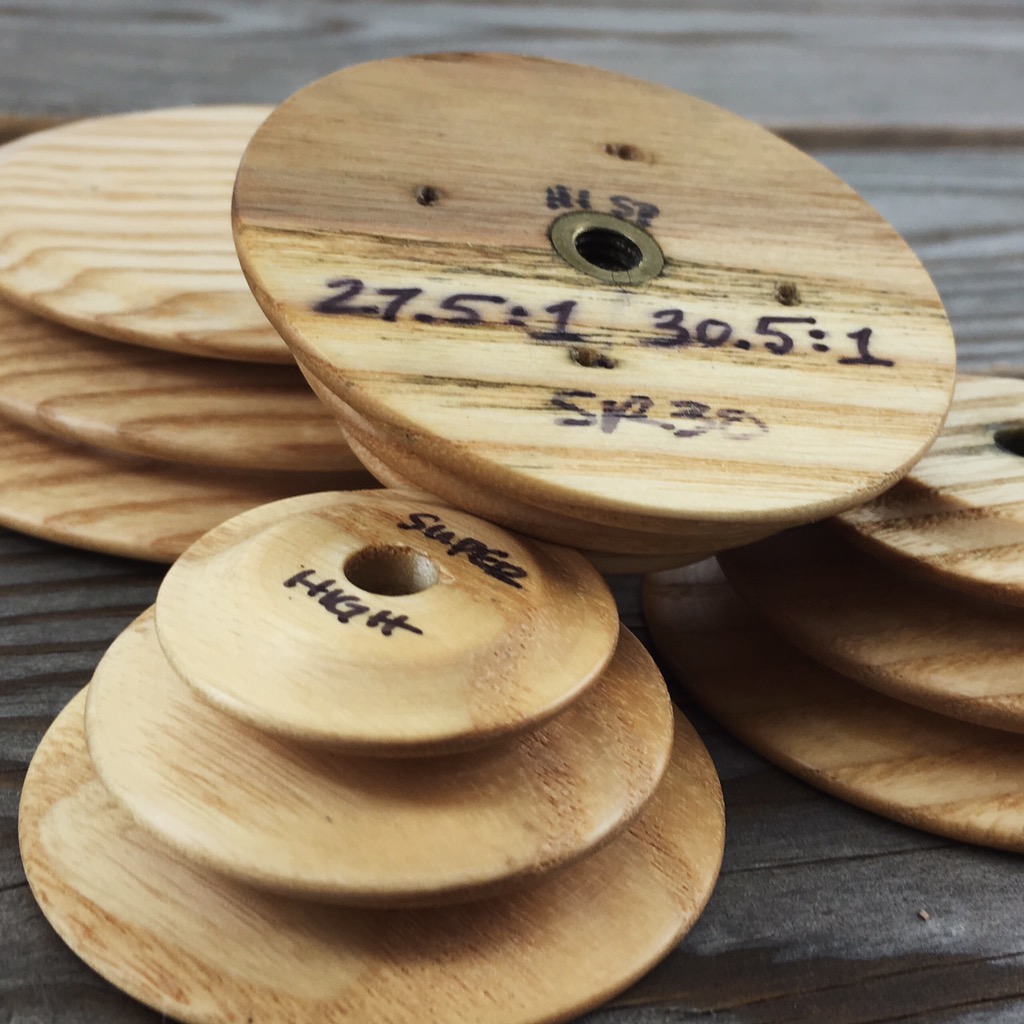 Whorls for my Schacht Reeves wheel. I write the ratio for each groove of the whorl on the back for easy reference. Because the drive wheel on the Schacht Reeves is very big—30 inches—the ratios are high.
