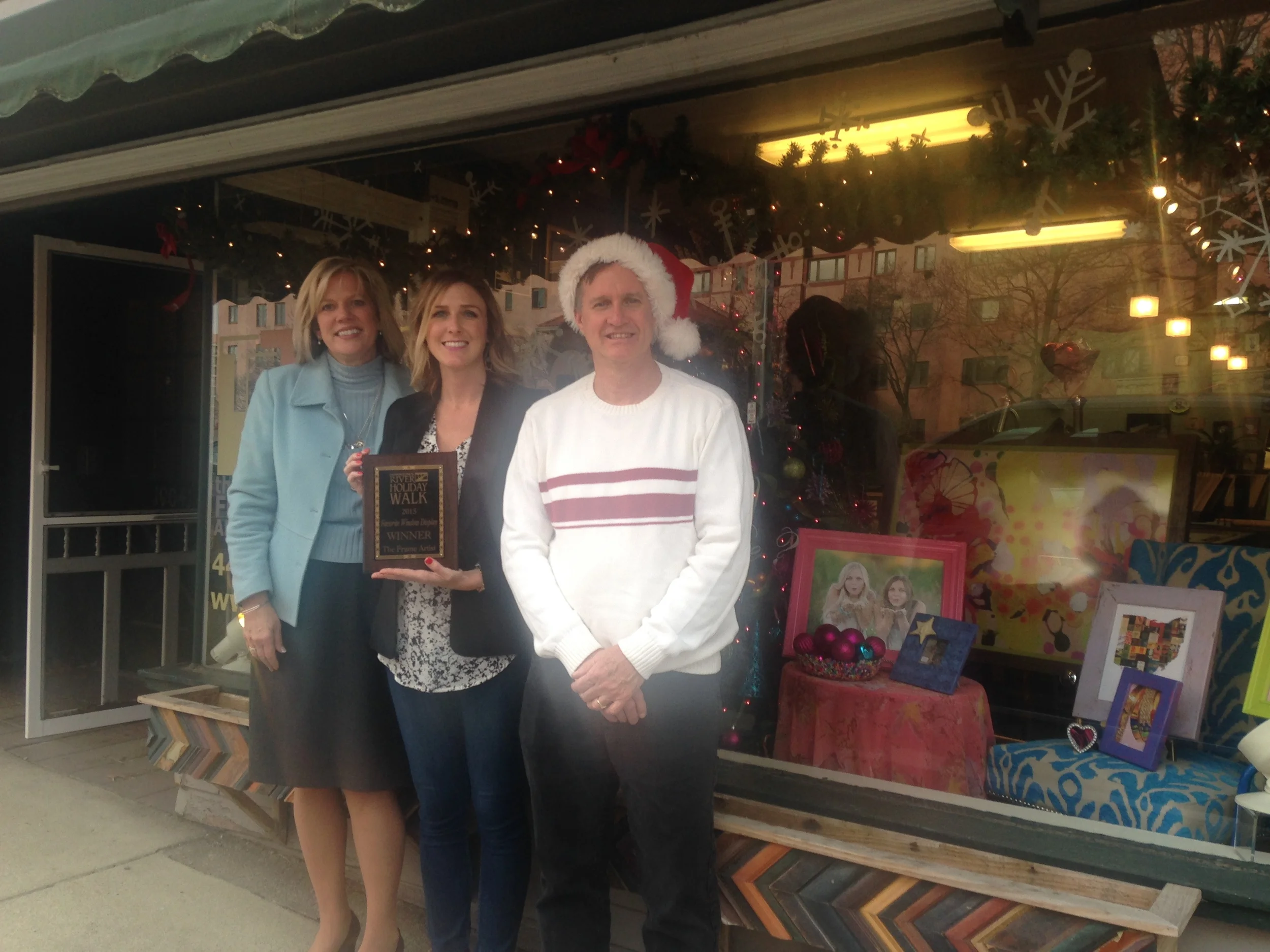 City of Rocky River Mayor Bobst, contest winner Amy Baumberger of The Frame Artist and Holiday Walk Coordinator Bill Brink