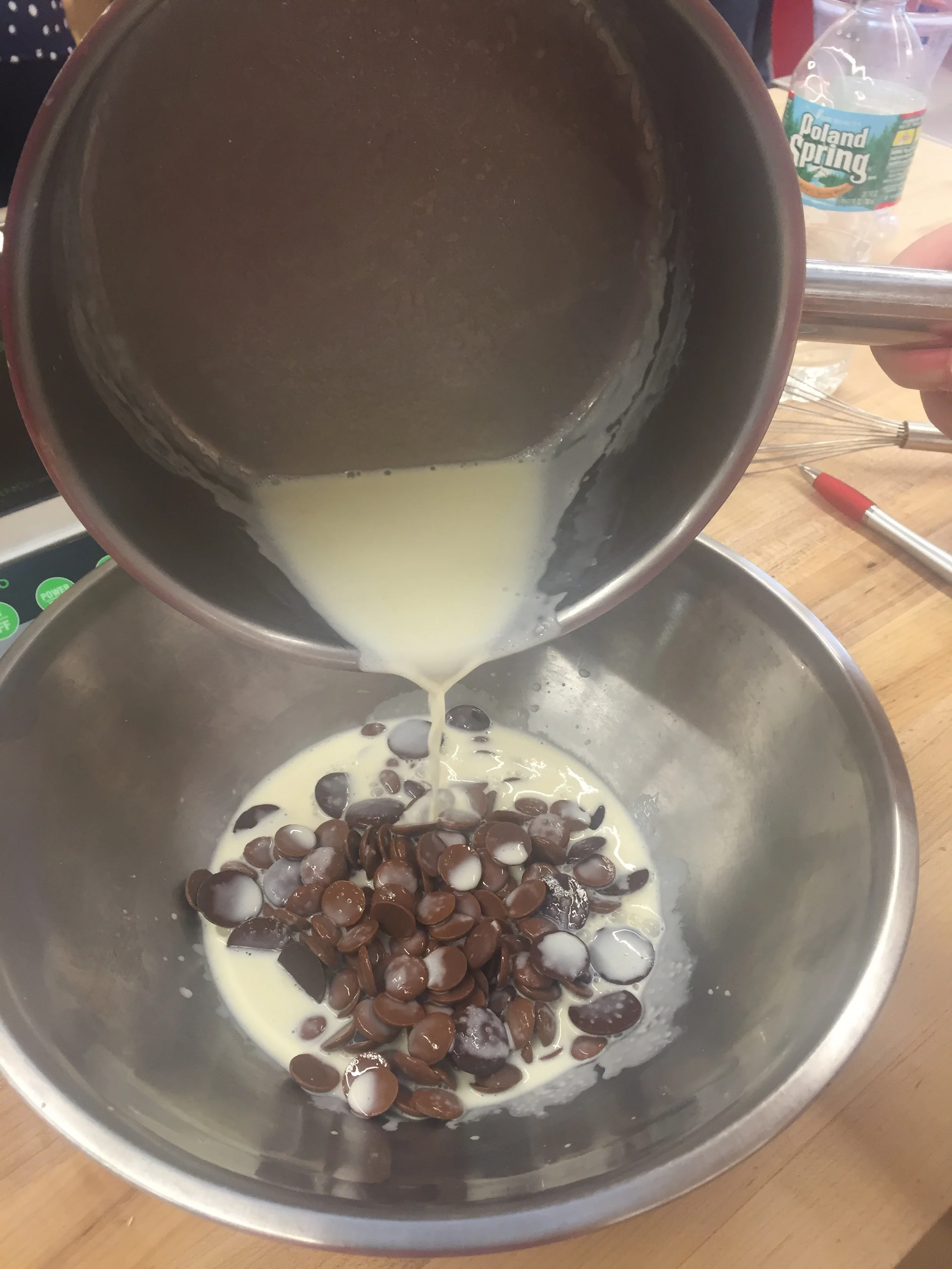 Adding our boiled milk and honey over a mix of milk & dark chocolate chips