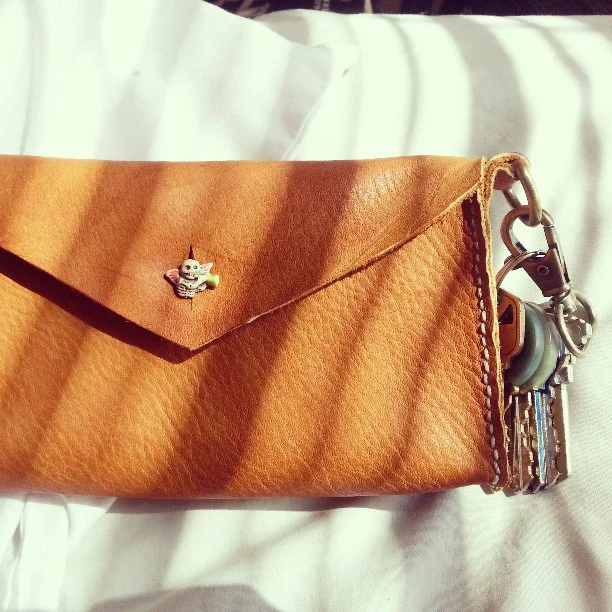 I made myself a purse! Saddle-stitched leather with a wool felt lining and an interior pocket for cards.