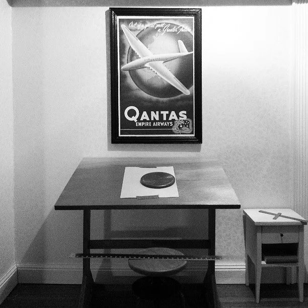 One more shot, with a penny for scale. The table tilts, the chair swivels to adjust the height of the seat, and the drawer on the nightstand opens.