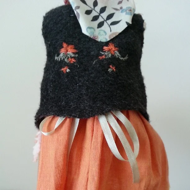 And, last picture, a bit of embroidery on her vest.