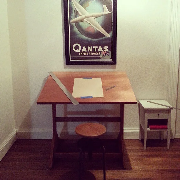 I made all of the furniture in here from scratch a few years ago. The drafting table and swivel chair are made from cherry and steel, and the nightstand is basswood! The scale is 1’ to 1”.