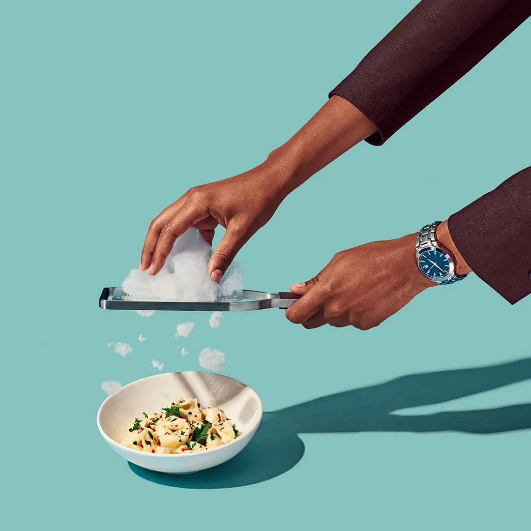 client: virgin atlantic credits: photo- jenna gang, food styling- ali nardi description: conceptual still life photograph of modeling shaving cloud parmesan on pasta.