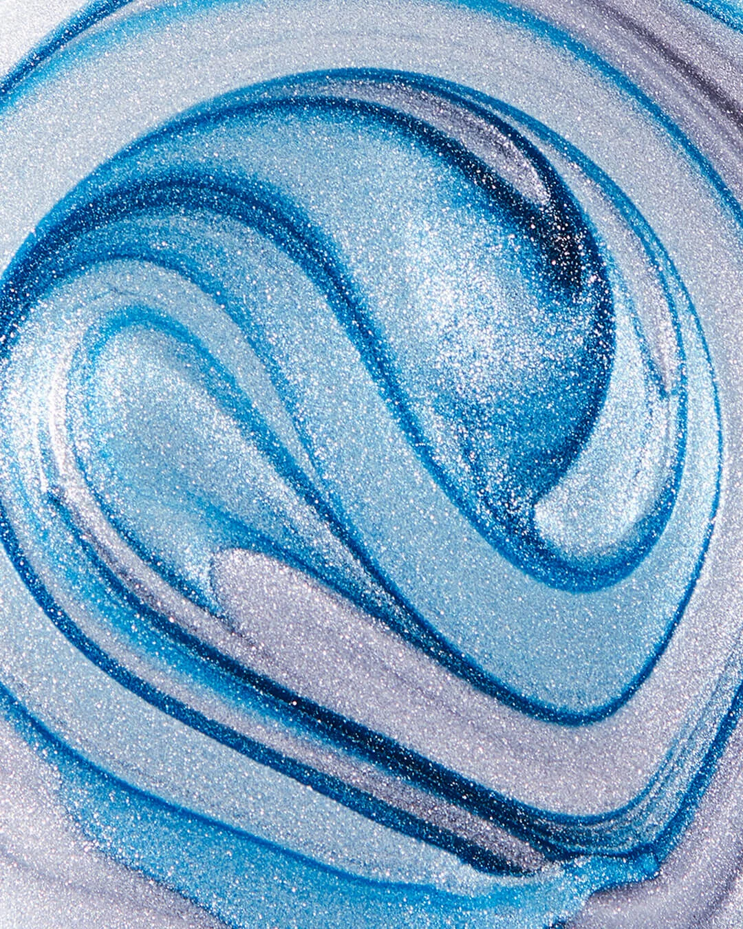 credits: photo - jenna gang, styling - astrid chastka description: conceptual still life image of a blue swirl nail polish texture.