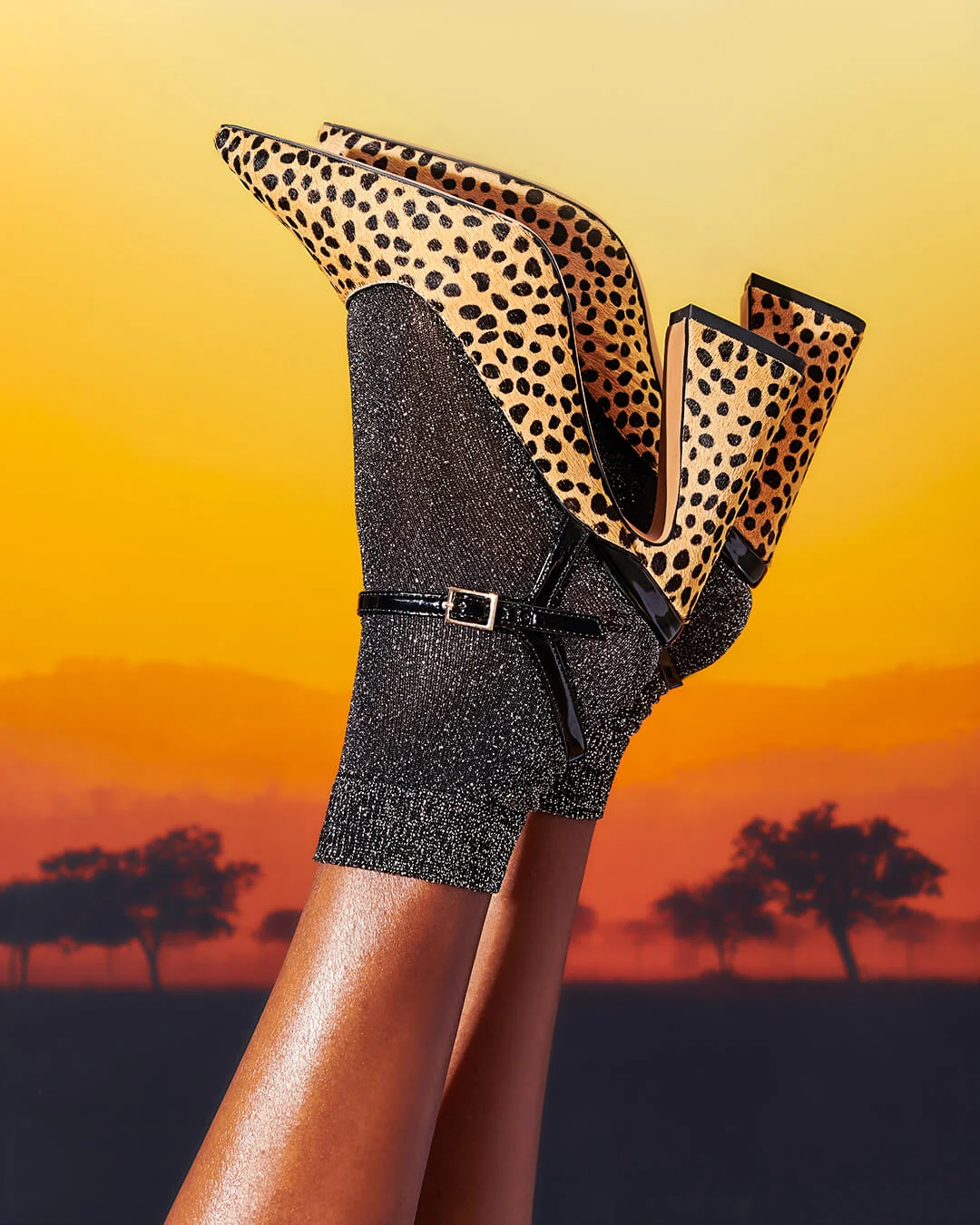 credits: photo - jenna gang, wardrobe - ross mccallum, sets - caylah laes description: model wearing fake leopard shoes and glitter socks by a sunset background.