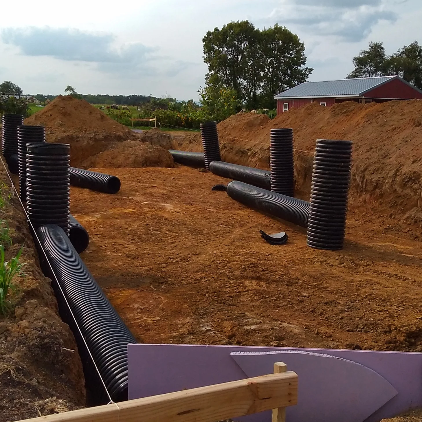 Assembled risers showing the excavated area. The large boulder is in the far end and blocks a portion of the manifold.