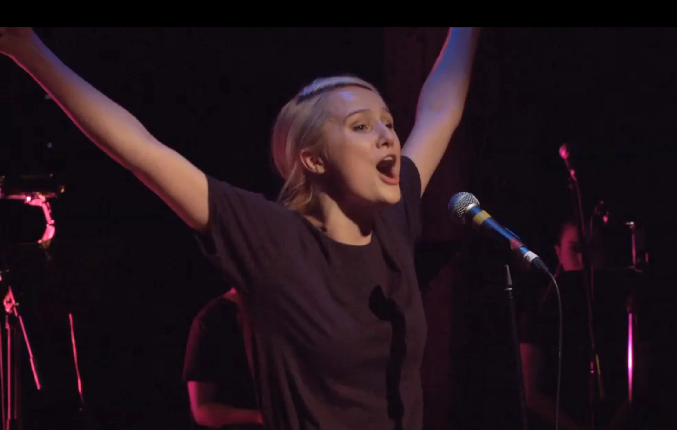 Yve Arms up singing crop.jpg