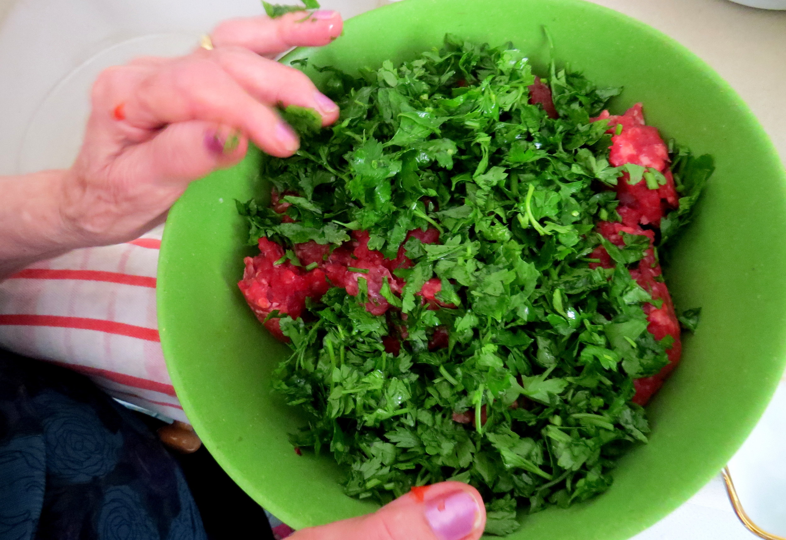  Like many of the grandmothers, Rina uses her hands for mixing.