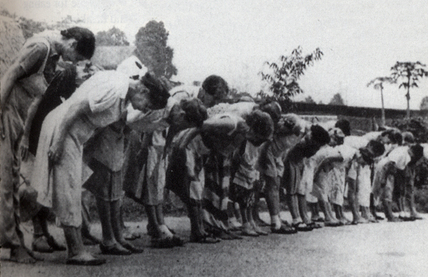 Women bowing to the Japanese flag at a POW camp. 130,000 civillians were interred in Indonesia during WWII.