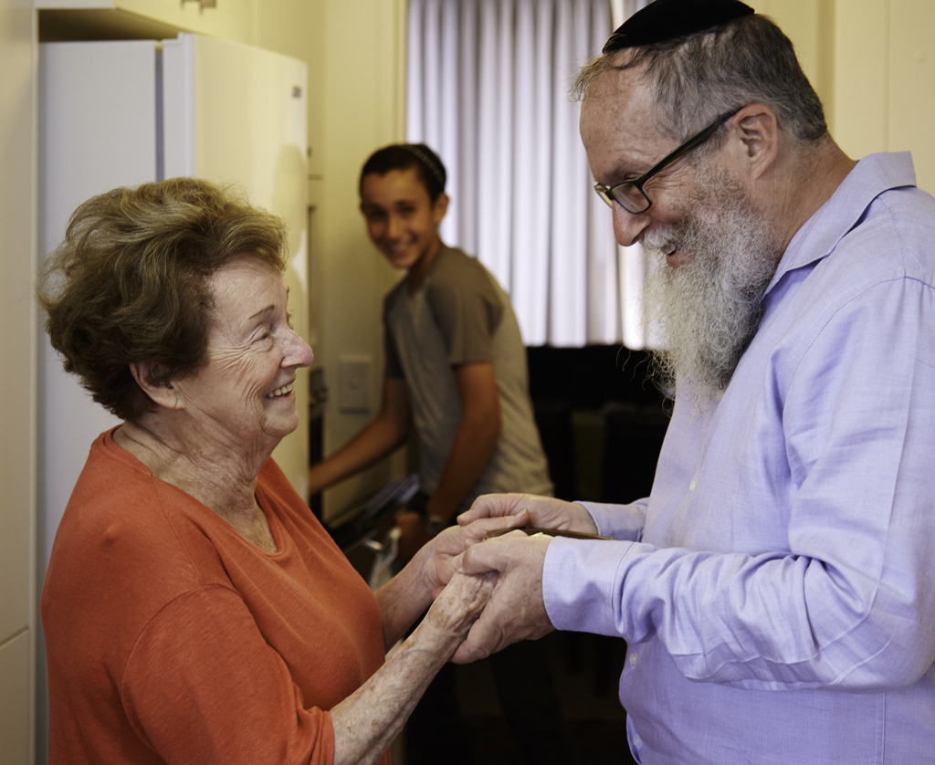 David Deitz sharing a moment with his mother Mimi, his son Levi in the background.