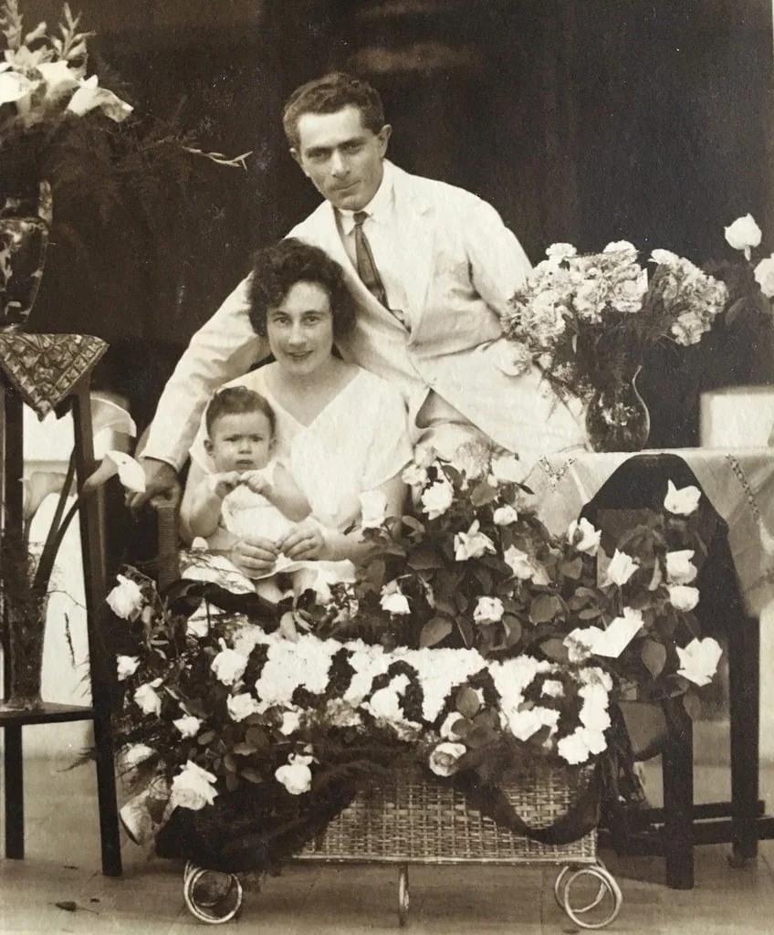 Thea's parents with her as a baby in Indonesia