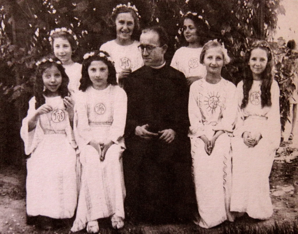 Communion, 3 June 1943, The Convent of Sisters of Immaculate Conception Wasaw. Judy's sister Tosia is sitting to the left of the priest. She is not the only Jewish girl in this group. In fact, 4 out of the 7 girls are Jewish!
