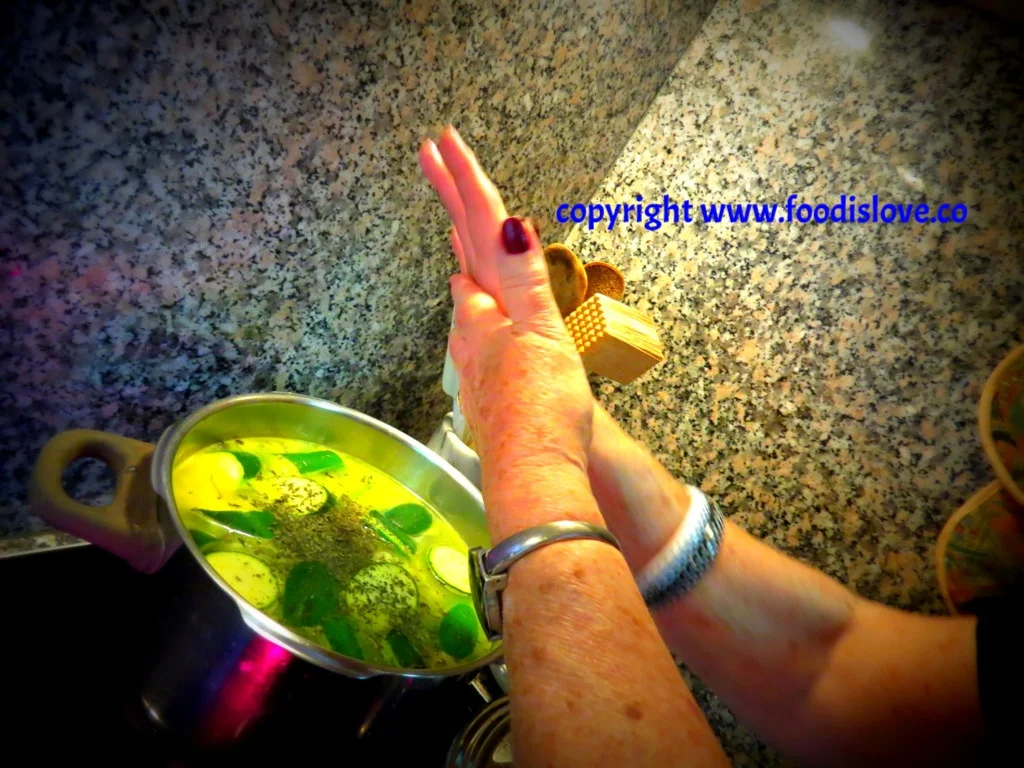Viviane crumbles dried mint into the soup .
