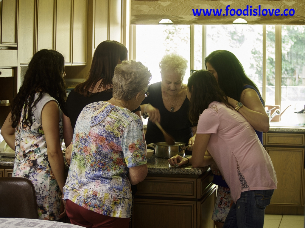 Viviane Levy, surrounded by daughters-in-law and cousins as she explains the secrets of her Yellow Soup