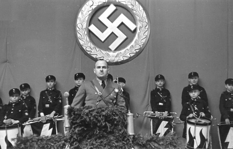 Above: Chief Nazi administrator in Poland, Hans Frank, addresses a Hitler Youth meeting in Tomaszow. Below: Left, Nazi leaders visit Tomaszow; Right, Jews of Tomaszow are rounded up. In 1941, 1500 Jews were deported to surrounding towns. In 1942, around 15,000 Jews they were deported to to the death camp of Treblinka