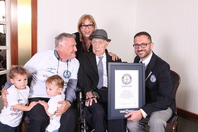Yisrael Kristal with Marco Frigatti from the Guinness Book of Records, son Chaim Kristal daughter Shulamit Kuperstoch and 2 of his great grandchildren. March 2016 (Dvir Rosen/Guinness World Records/Associated Press)