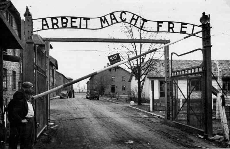 The famous words above the gates at Auschwitz. 'Arbeit macht frei - Work will make you free'. For more than a million people here, it was a cruel hoax. They were all murdered. The only thing that set them 'free' was death. But a small number of young fit people who arrived late in the war, like Tooby, were saved by being taken away from Auschwitz to work as slave labourers. 