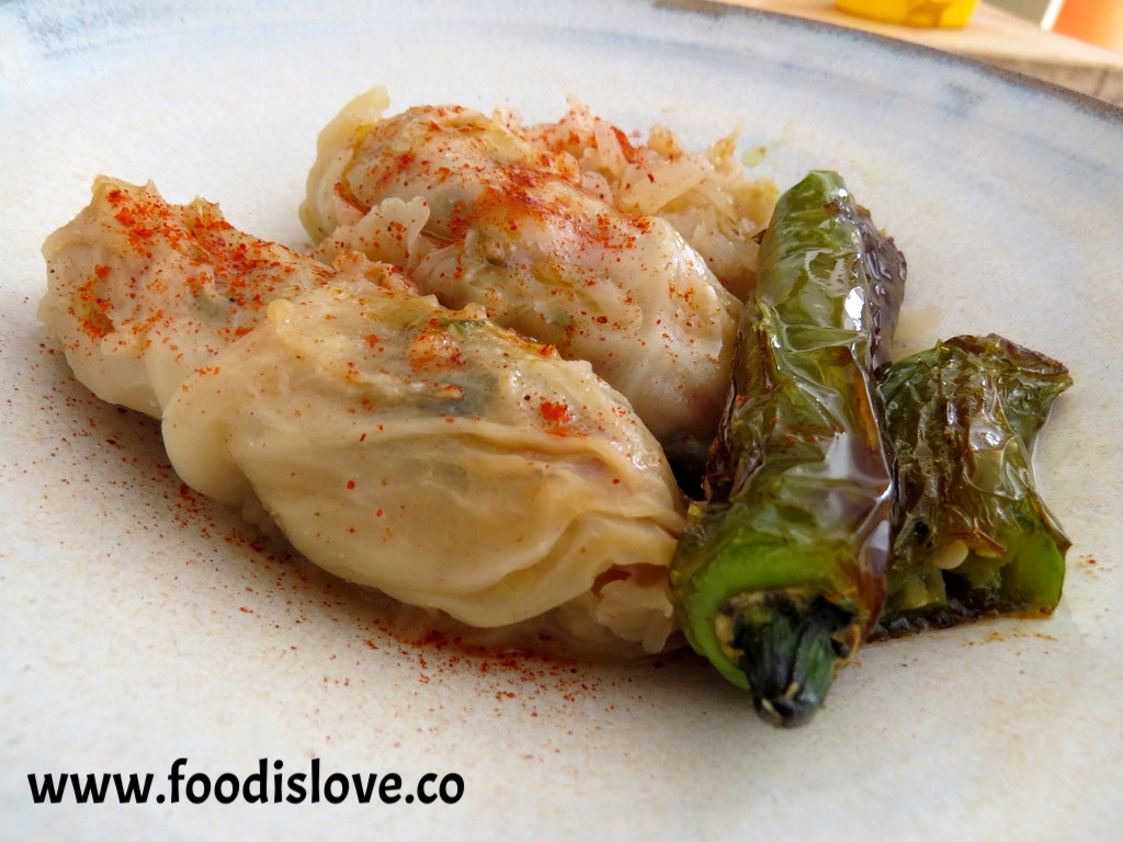 Vegan cabbage rolls served with seared jalapeno peppers and smoked paprika. 