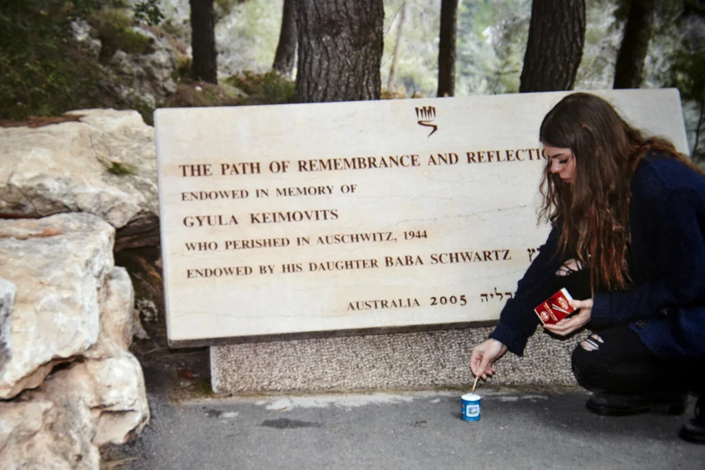 Baba's grand-daughter Delilah Schwartz lights a candle on the path of remembrance, which Baba endowed in memory of her father at Yad Vashem, the Holocaust Memorial in Jerusalem. 