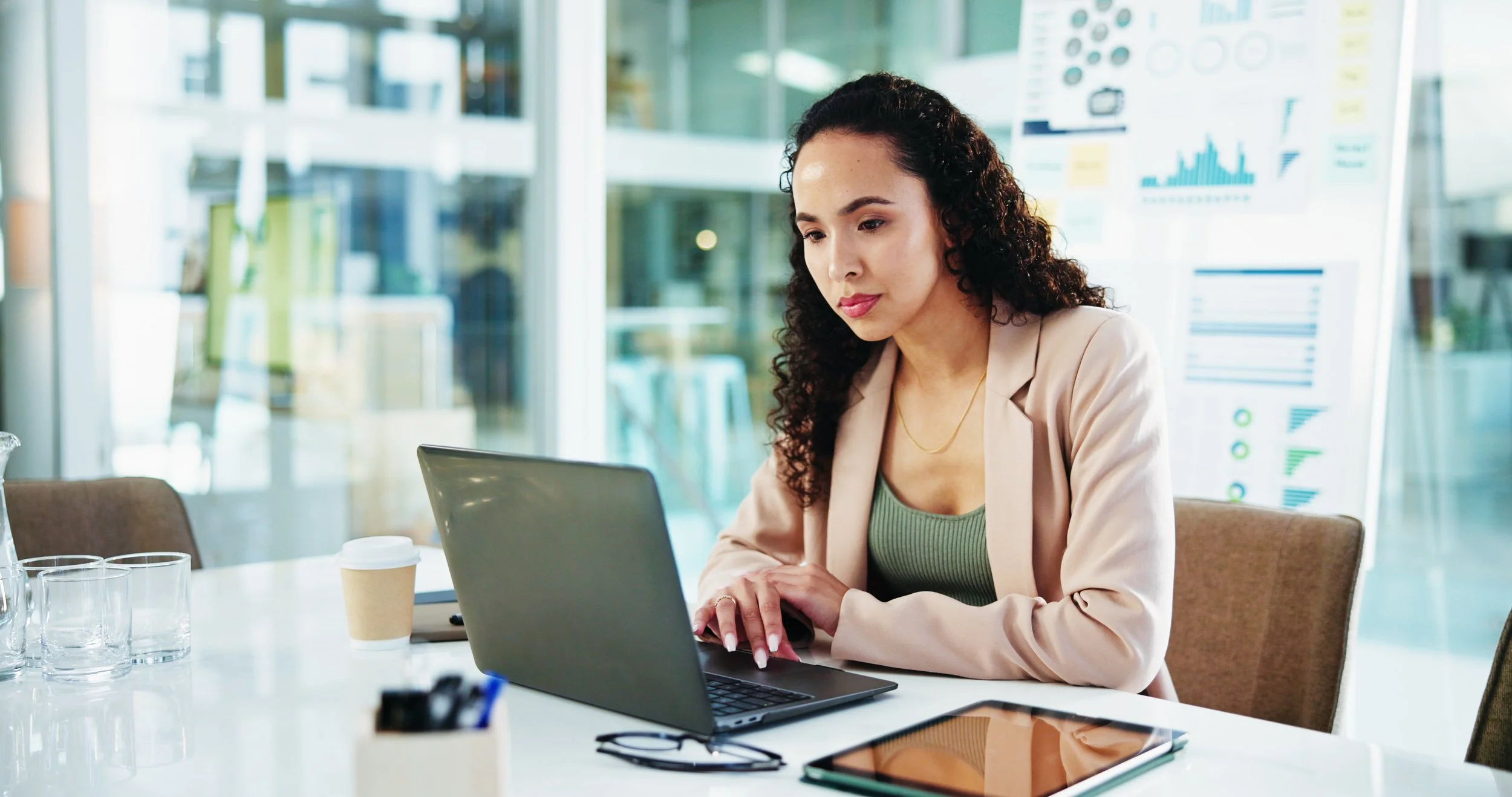 Professional reviewing equity and vesting schedule on a laptop in an office setting.