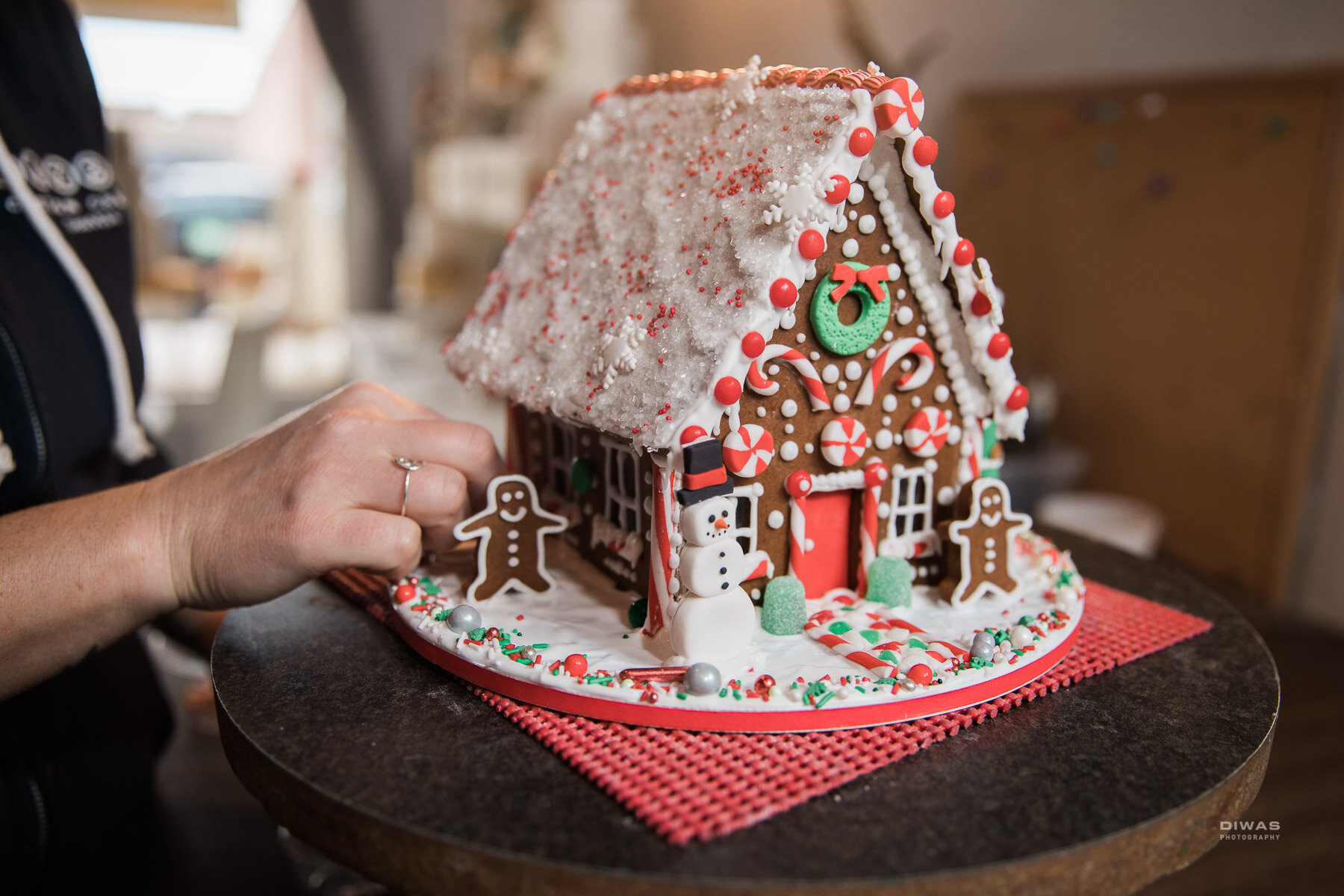Use the remainder of your icing to spread on the board to make a snowy scene and attach your decorations.