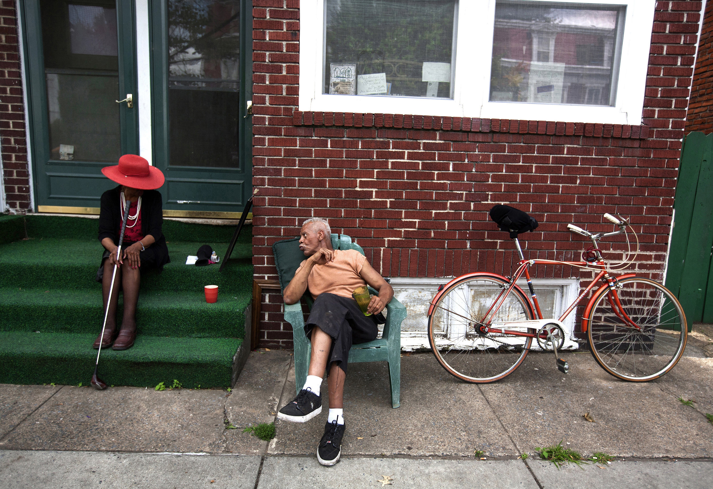  Esther Edwards, 83, sits on her front step while waiting for the police to pick up an intoxicated man who fell off of his bike in front of her home in Harrisburg, Penn. Edwards can often be seen dressed to impress with a golf club in hand, that she 