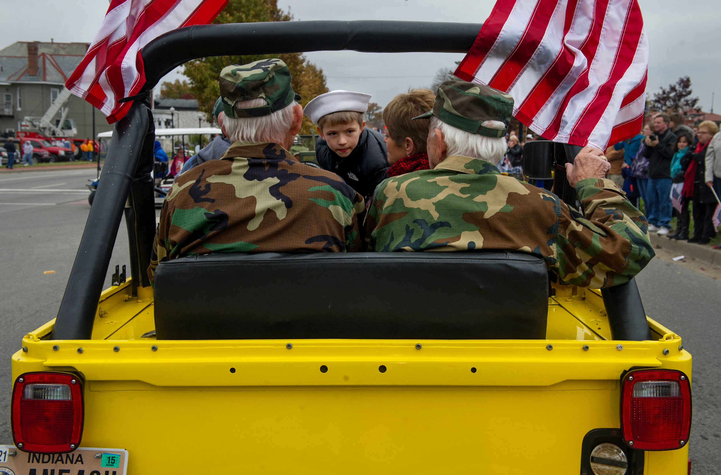  World War II Army veterans and brothers Dwayne Hume (left) and Donald Hume (right) ride with Joey Langerak, 7, of Evansville in a 1978 Jeep during the Veterans' Day Parade in on Riverside Drive in Evansville Saturday, Nov. 8, 2014. 