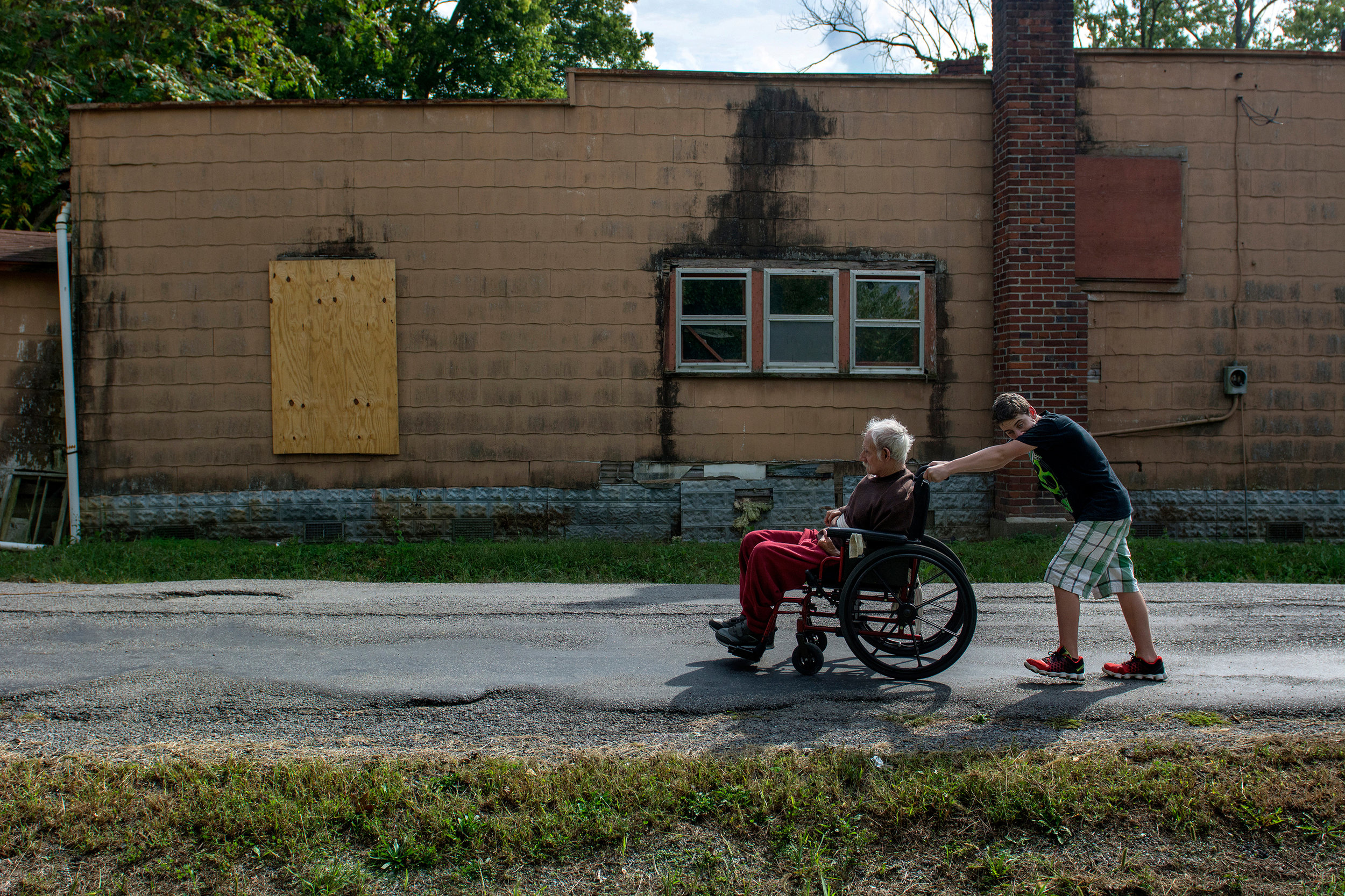  Chico Bordoy, 13, pushes his father Ramone Bordoy, 72, to their home in Muddy, IL where they live with Chico's adult sister and brother, with special needs. Ramone said he lived in Muddy when he was younger and moved back along with his children so 