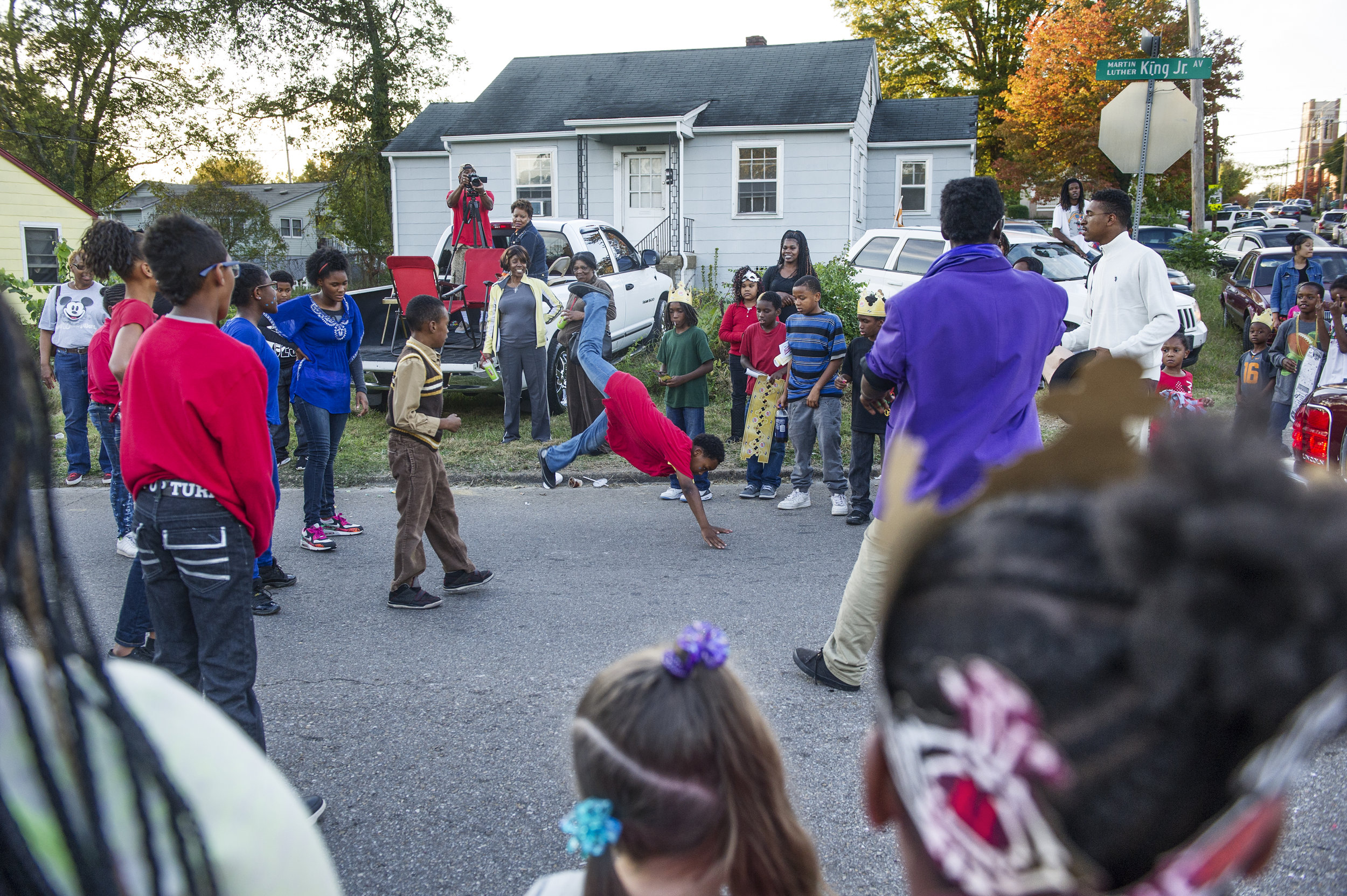  Parade goers watch Presean Brown, 10, (center) dance during the Divine Urban Expression Dream Team's performance at the Austin East high school homecoming parade Friday, Oct. 23, 2015. 