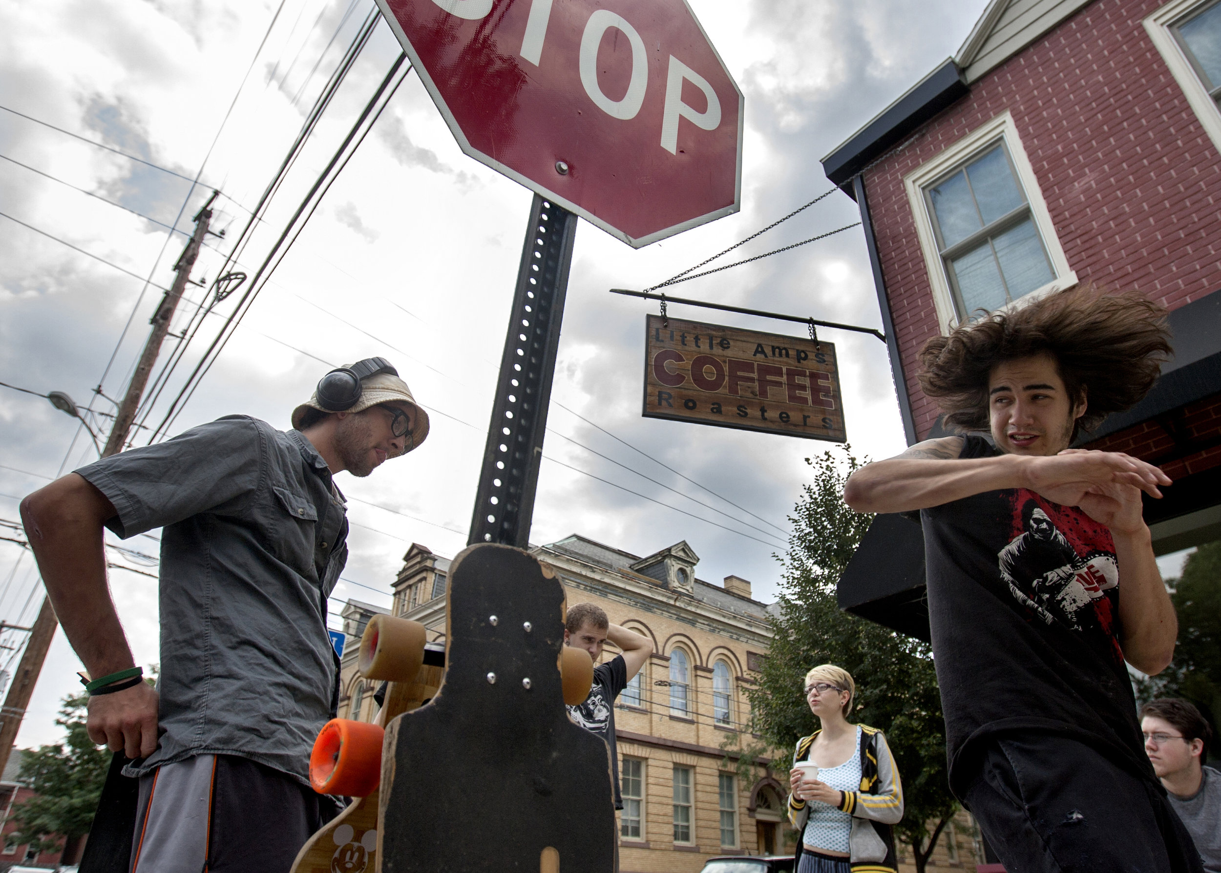 Jesse Horsford, left, and Chris Siennick hang out in front of Little Amps coffee shop on Green Street in Harrisburg. The group is known around town for having their skateboards wherever they go. Along with skating, some of them also have taken up learning martial arts and have contemplated starting a band. "Being young in Harrisburg is actually kind of cool," Siennick said.