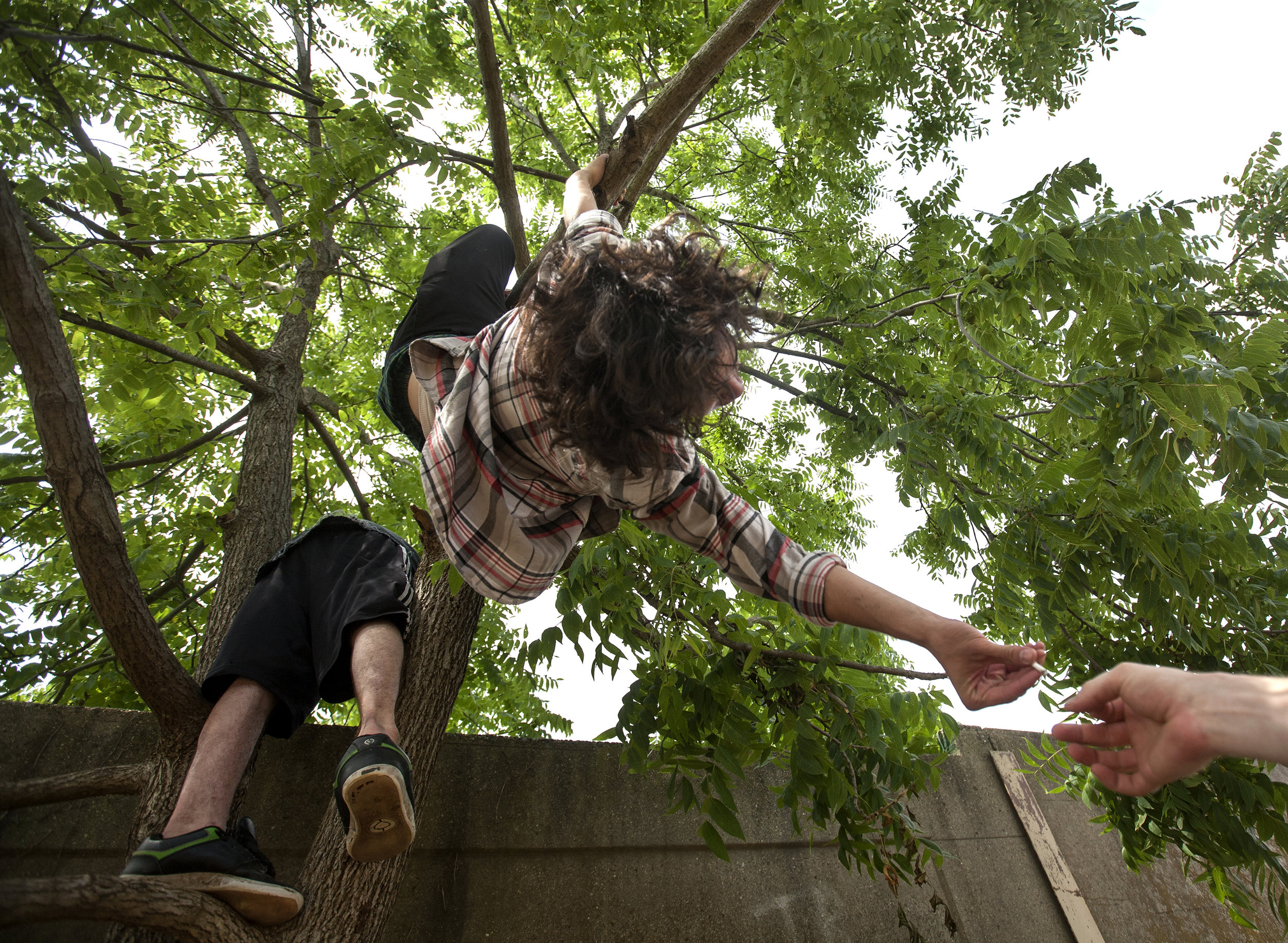 Chris Siennick passes a joint during a break from skating with friends. Most members of the group are on break from college, or no longer attend, and have various jobs in the Harrisburg area. "I realized you don't have to go to school to be creative," Siennick said. His goal is to get sponsored for long-boarding as a source of income.