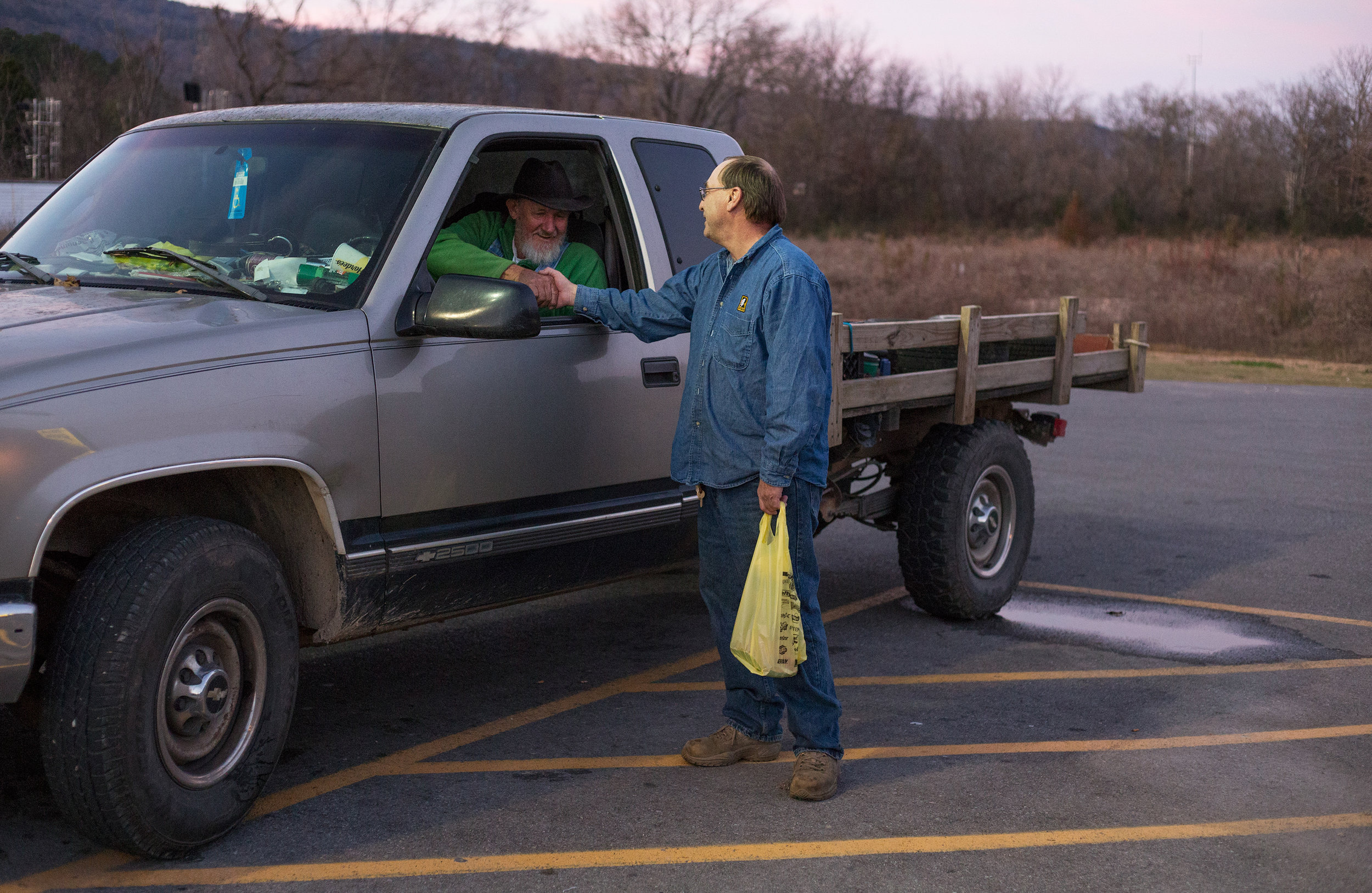  George Beaty, left, shakes the hand of Ed McClendon both of Evensville, Tenn. after running into each other at Dollar General in Evensville, Tenn. Thursday, Nov. 16 2017. Beaty said he has grown familiar with the staff at the store because he freque