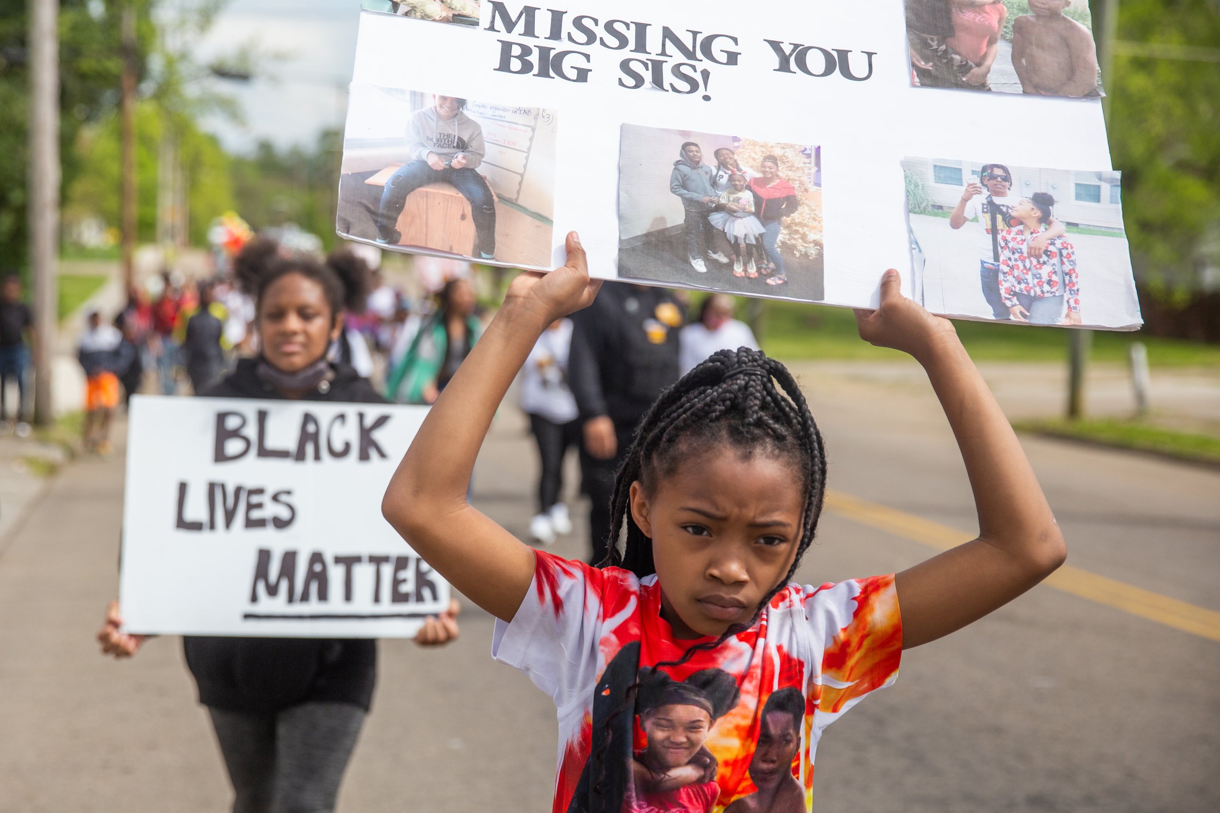  Anyia Mitchell, 9, little sister of Janaria Muhammad, 15, one of five Austin East Magnet school students killed due to gun violence this year, holds a sign during the M.O.V.E in L.O.V.E Youth Rally march put on to honor the lives of young people los