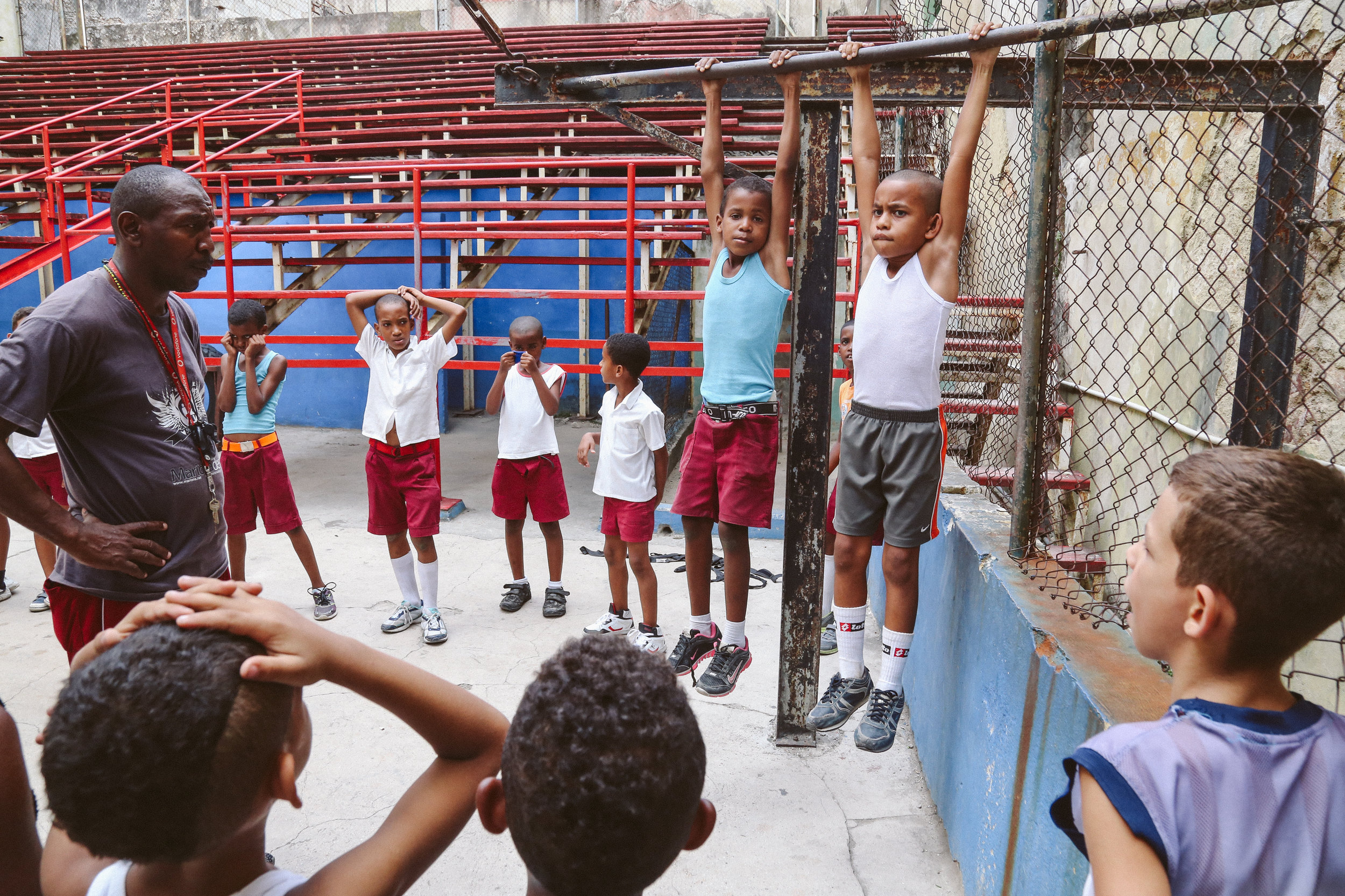 At the Rafael Trejo gymnasium Coach Pedroso leads the pack of young boxers ranging from ages 9 and 10 through a series of warm-up exercises and boxing moves. One of the exercises includes having students hang from a pole and see who can last longer. May 18th, 2016.